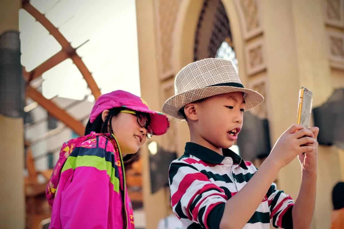 Two kids playing with a smartphone