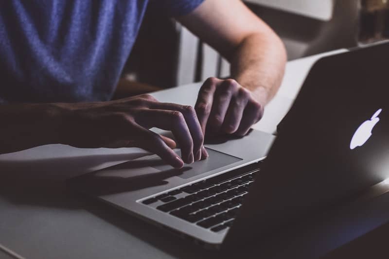 man using macbook pro to update his gamin maps