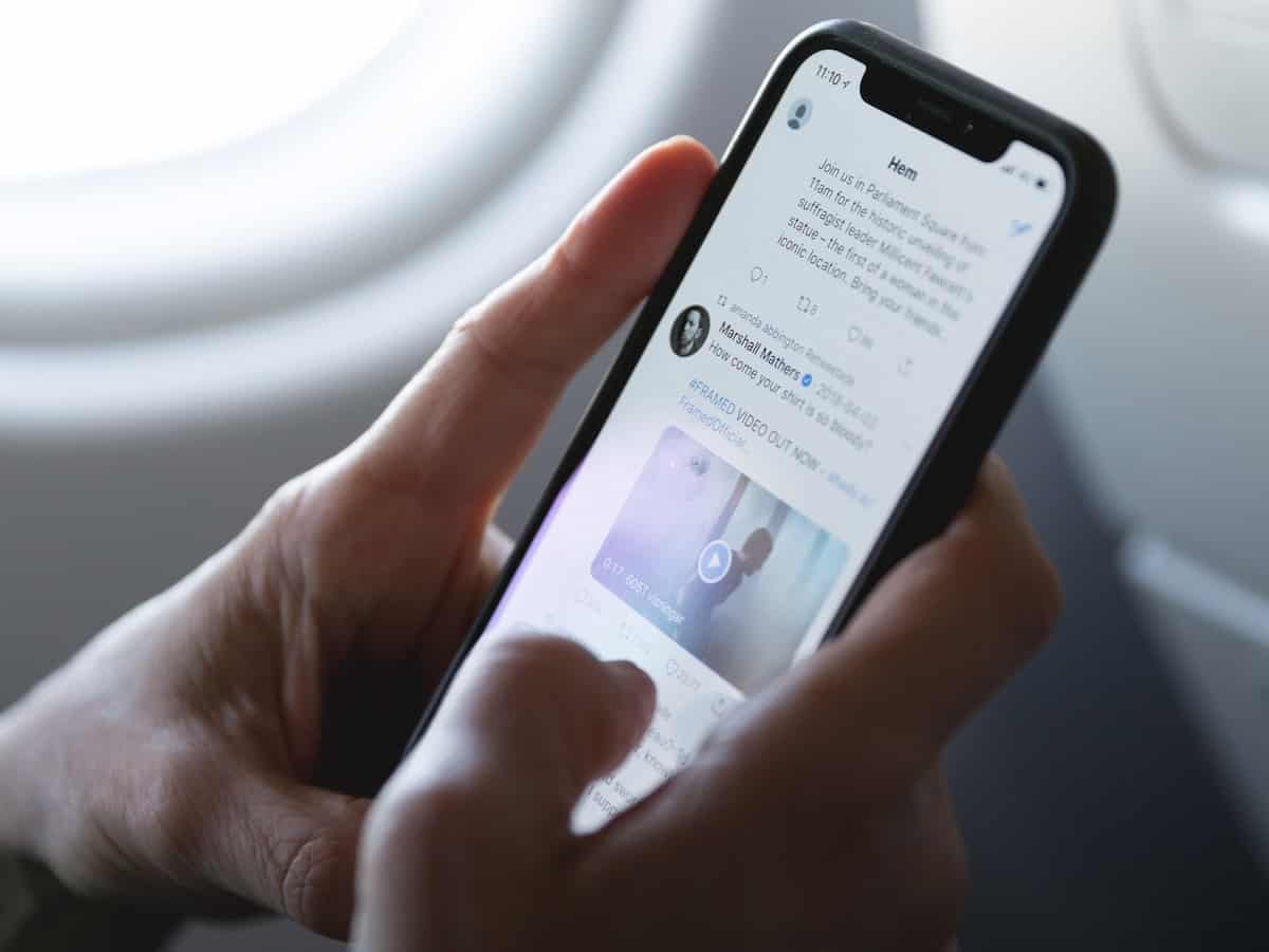 Man Checking his Twitter News Feed on The Plane