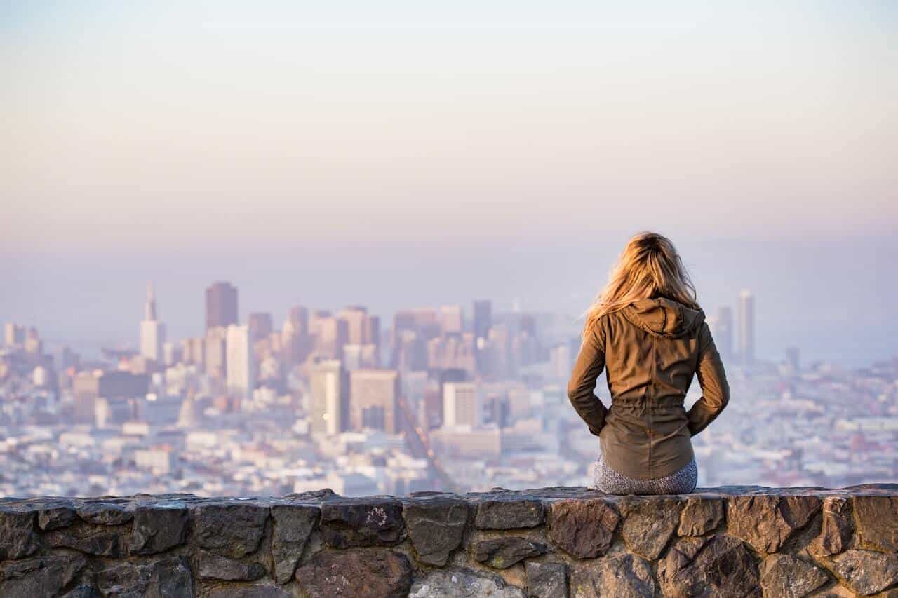 Woman Sitting on the Edge looking at the skyline
