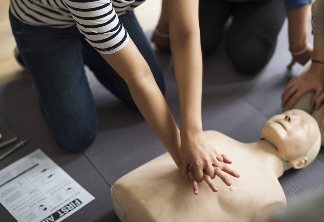person-performing-cpr-on-dummy