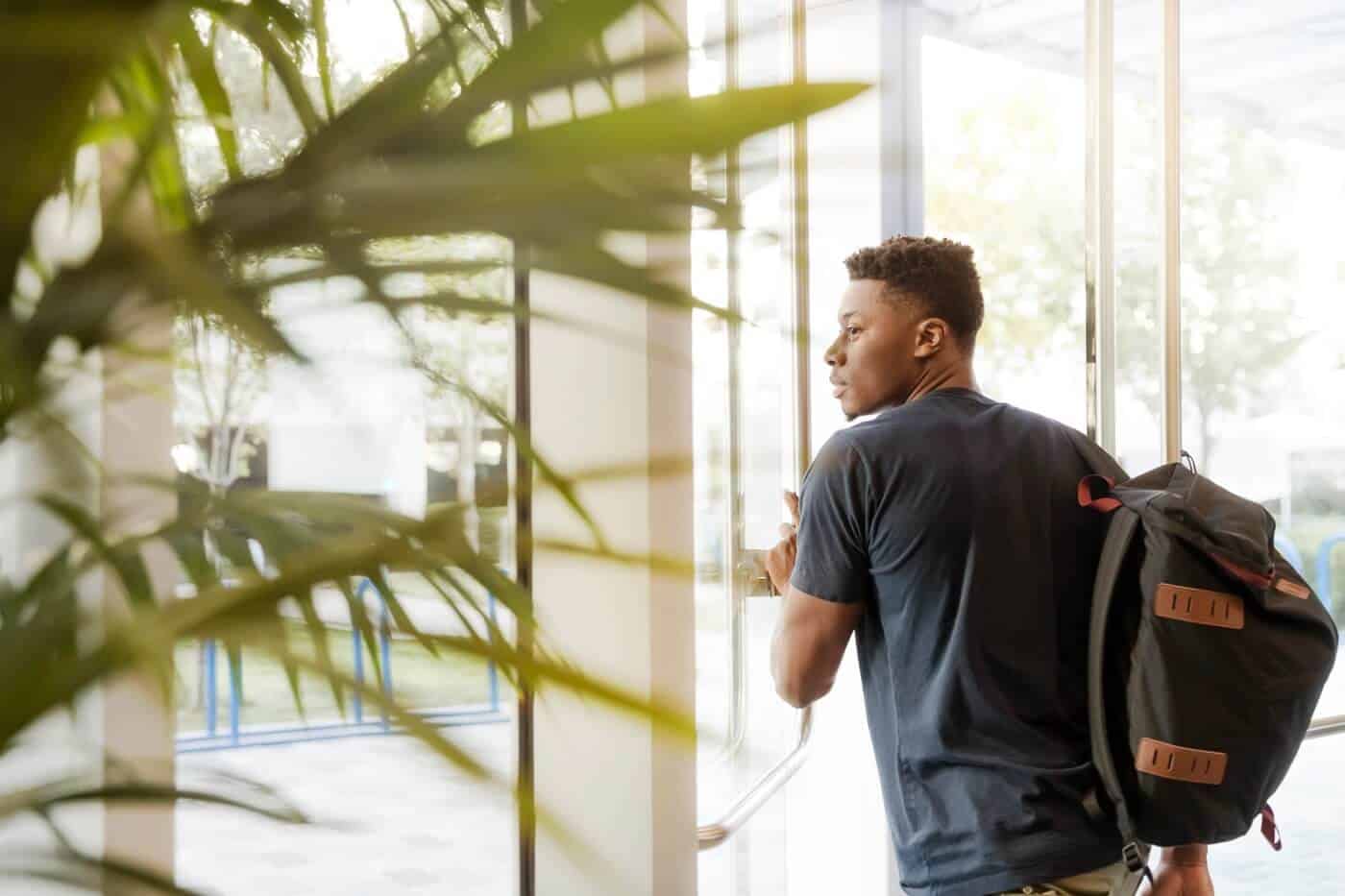 College Student Walking Out of a building