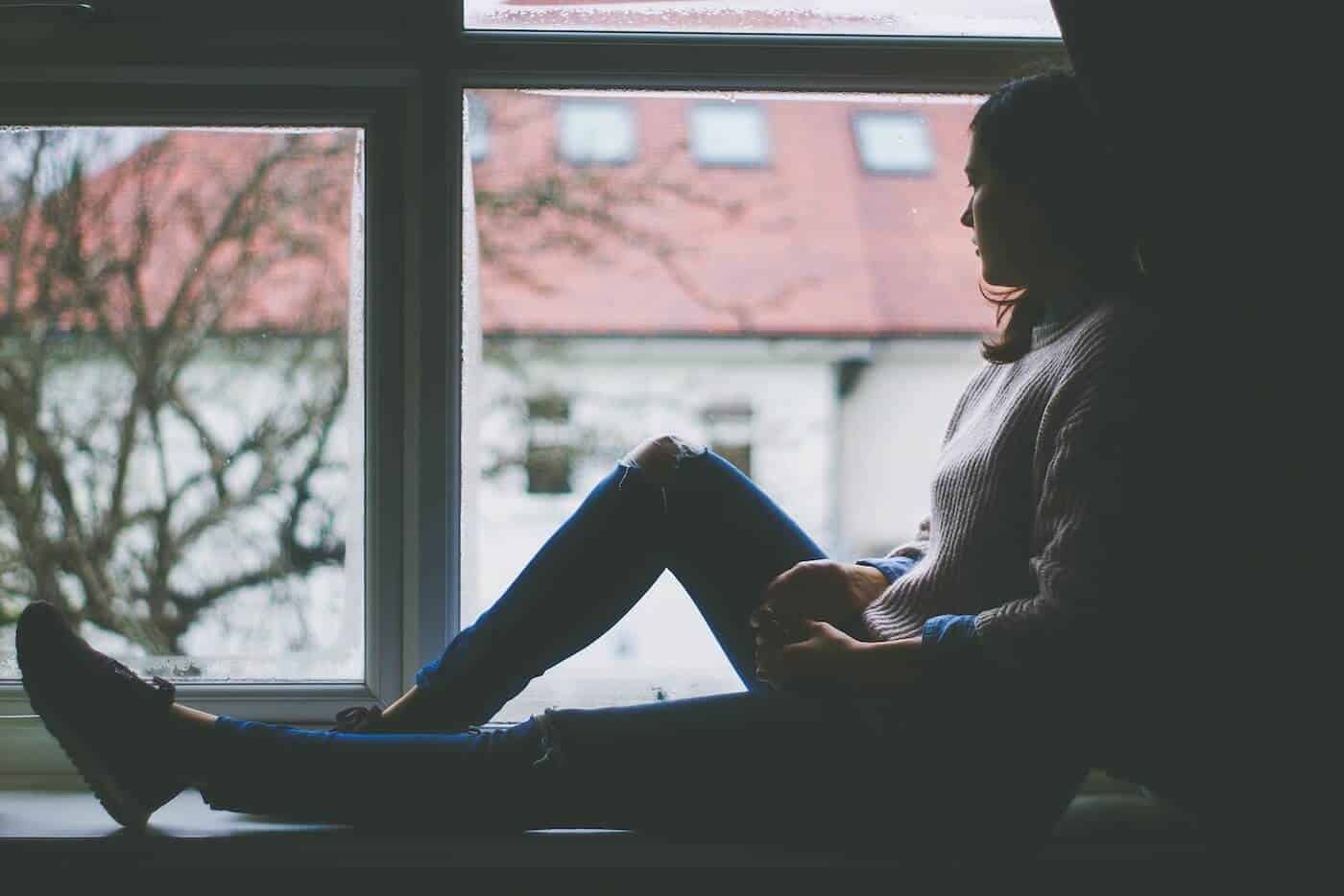 Depressed Girl Looking Outside The Window