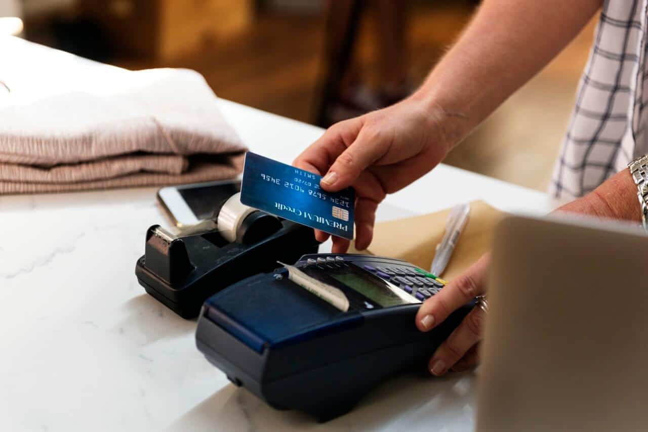 Person Holding Card and Terminal