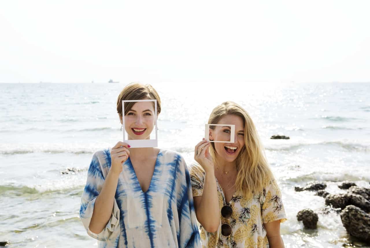 Two women using frames for a creative photo
