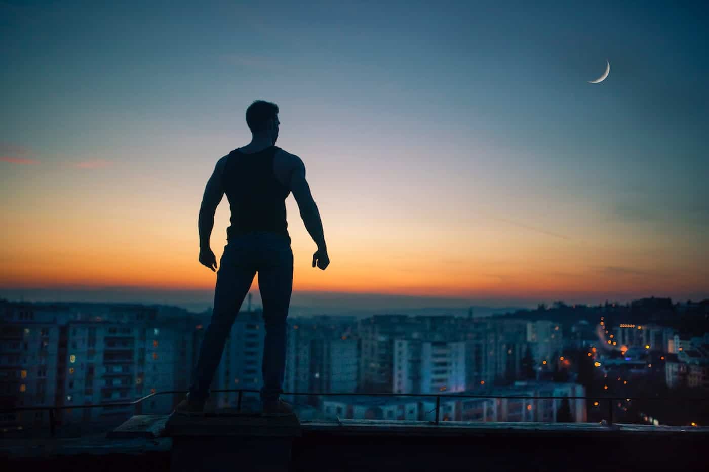 Man Overlooking a Cityscape during dusk