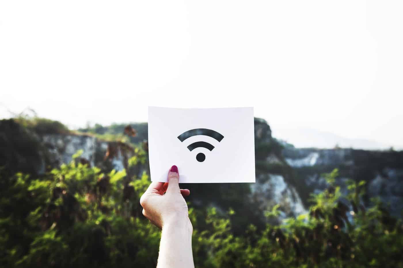 Woman holding up a wifi paper