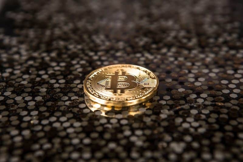 goldcolored Bitcoin coin on ground