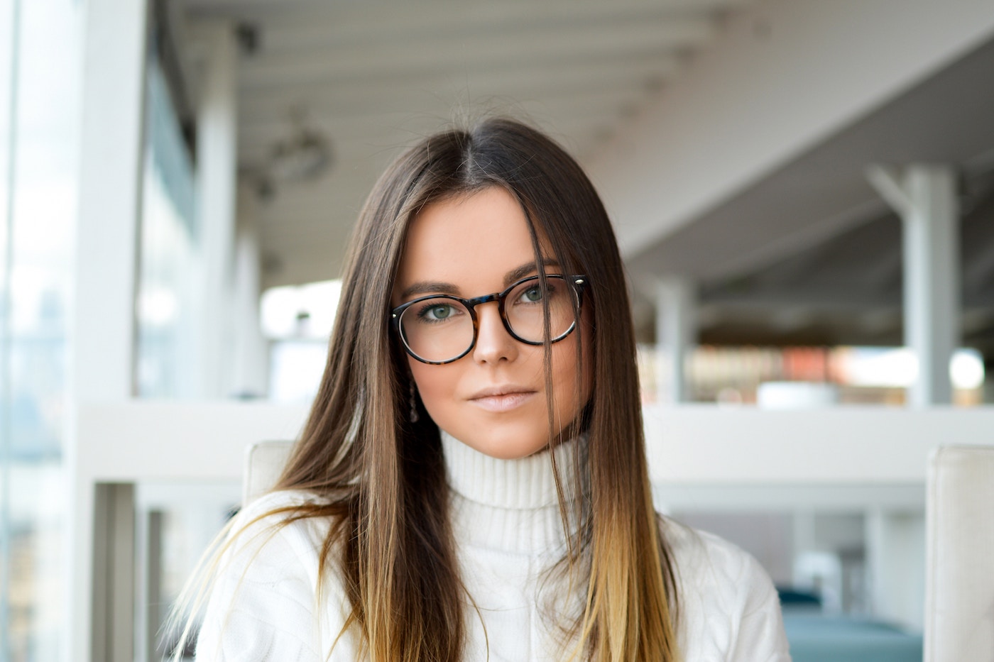 Gorgeous Woman Wearing Reading Glasses with a White Sweater
