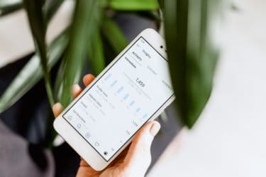Man Checking His Instagram Business Analytics on His Smartphone