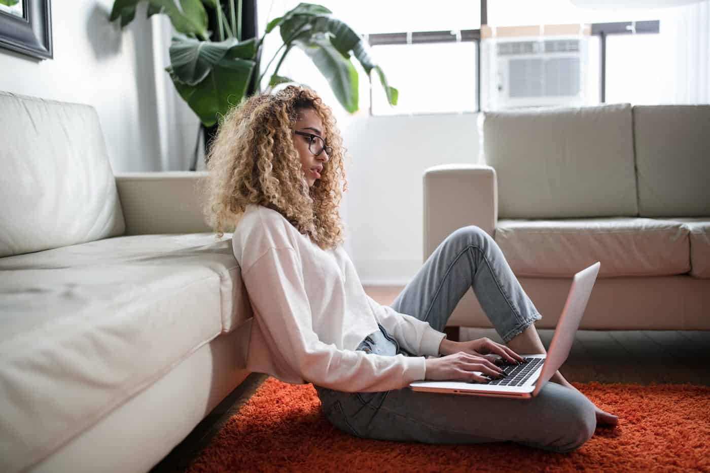 Woman Typing on Her Laptop Inside Her apartment