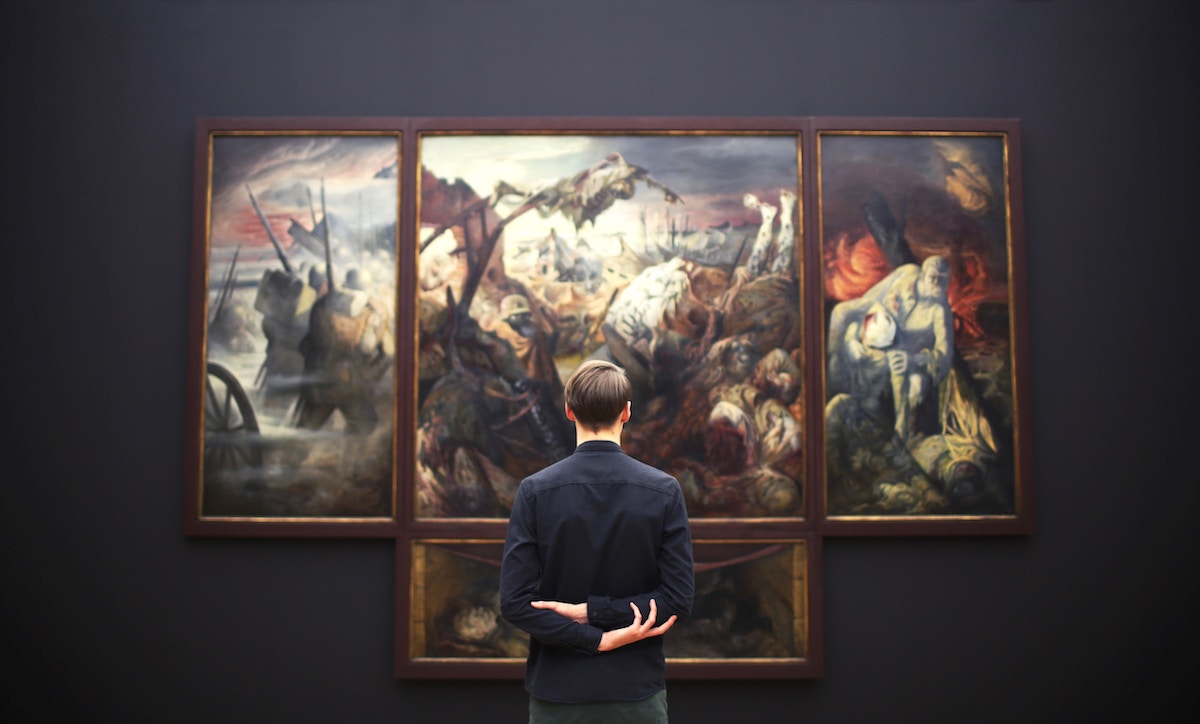 Man enjoying paintings at an art gallery