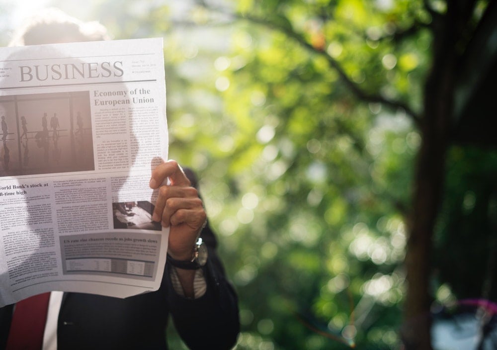 Man reading press release in the newspaper