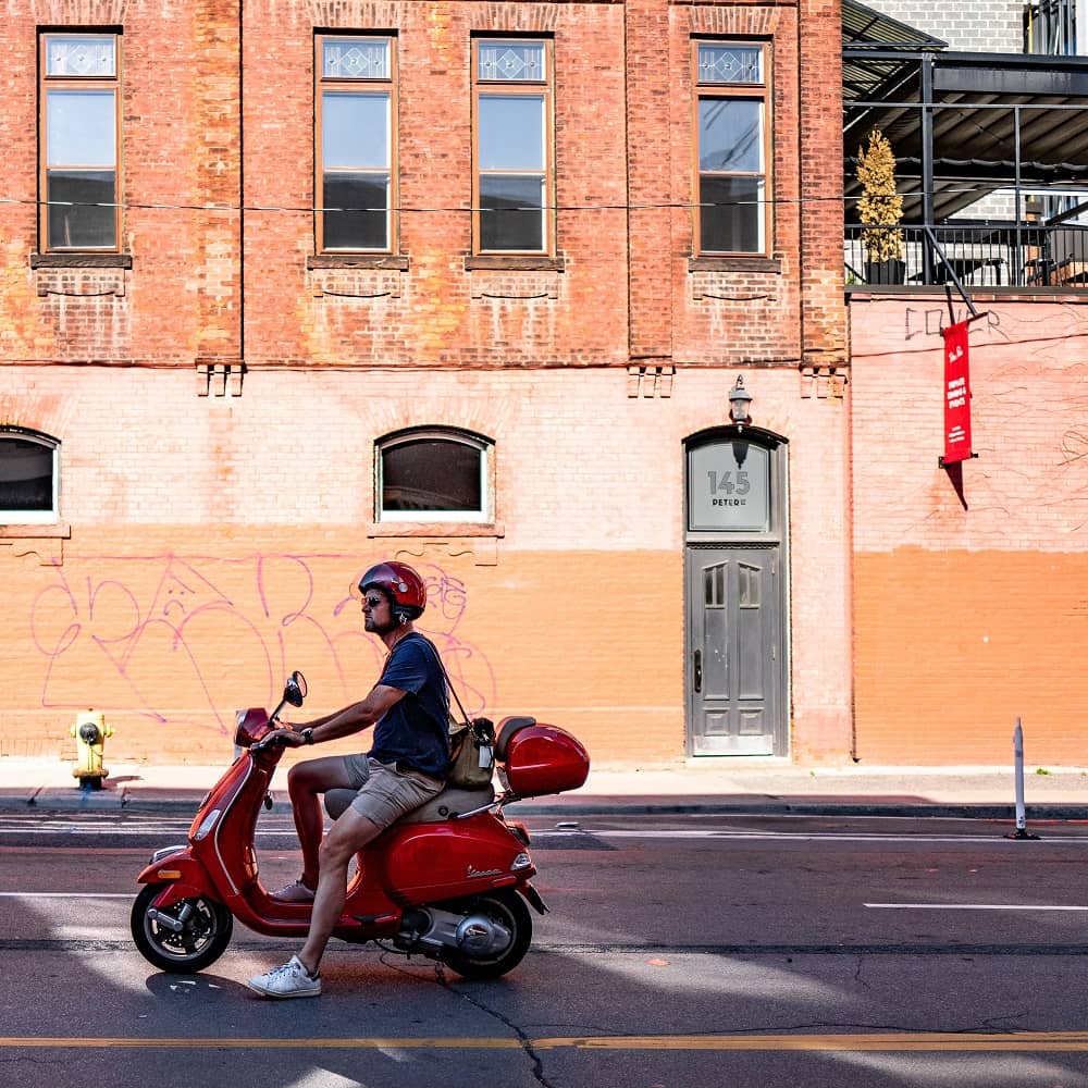 Man Driving a Scooter