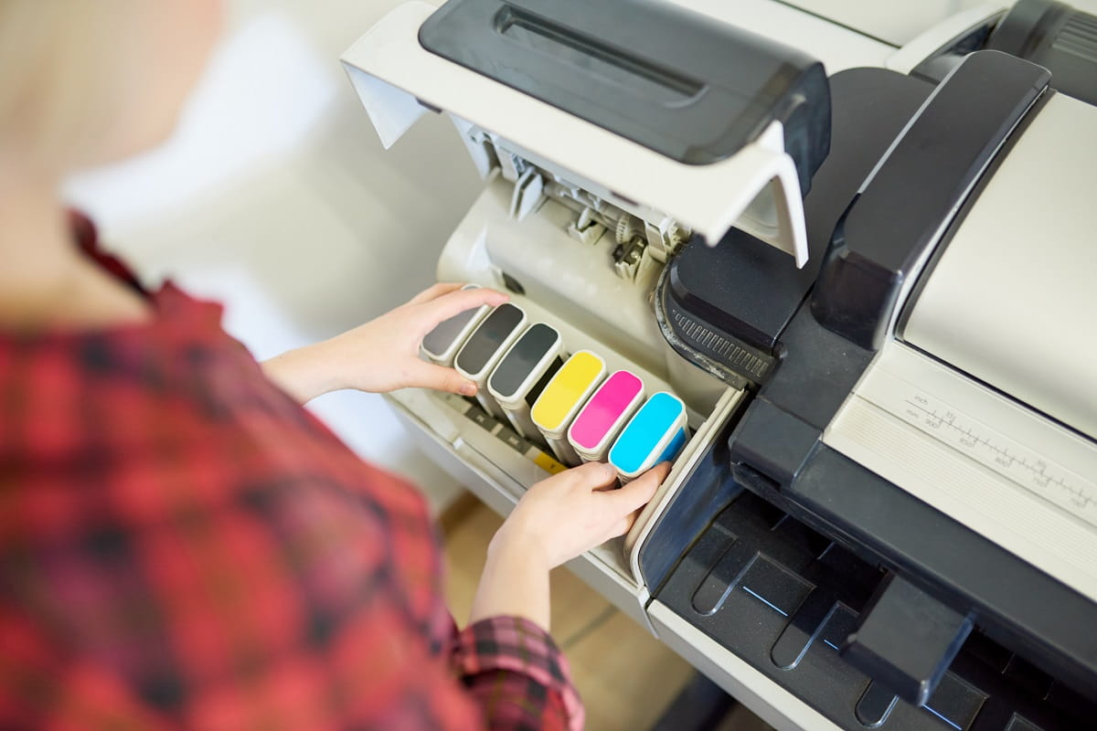 crop-woman-putting-ink-in-printer