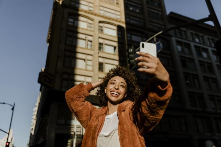 Black female blogger taking a selfied during sunset