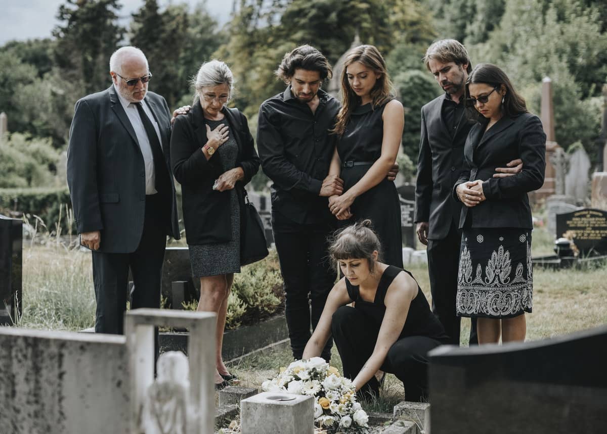 Family laying flowers on the grave