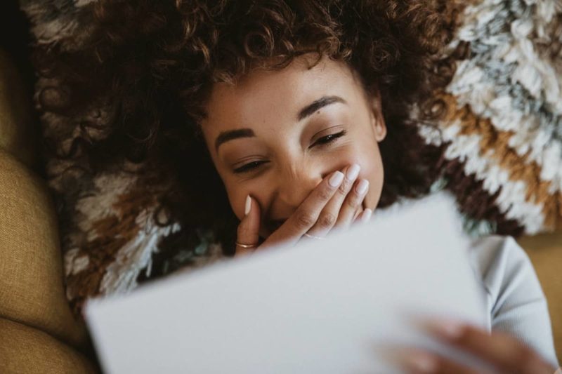 Woman lying and reading a love letter