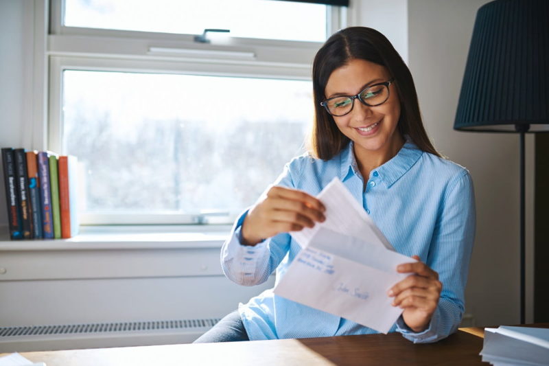 Young business entrepreneur checking her mail-min