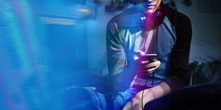 Young man using his phone in a room