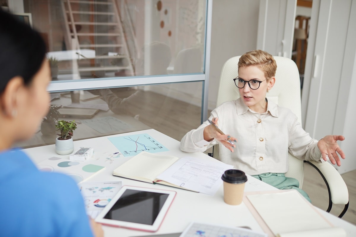 Contemporary Businesswoman Talking to Colleague