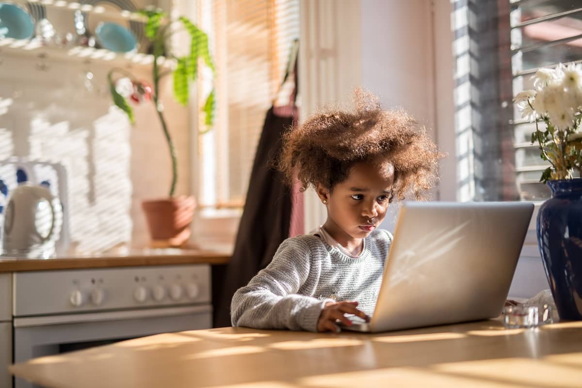 Kid using computer at home to learn programming