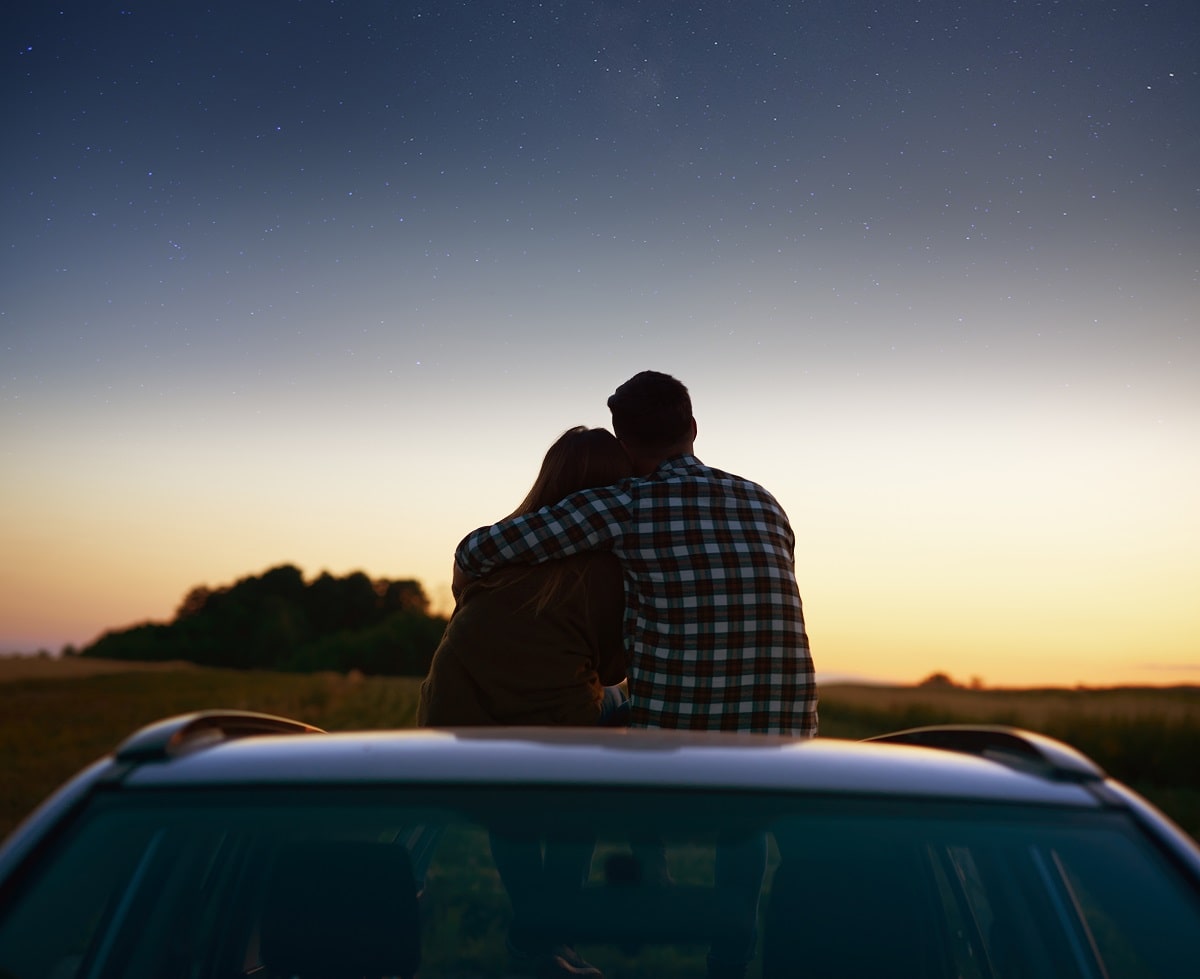 Rear view of loving couple enjoying the view at night