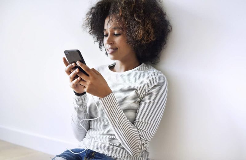 Smiling woman using a smartphone