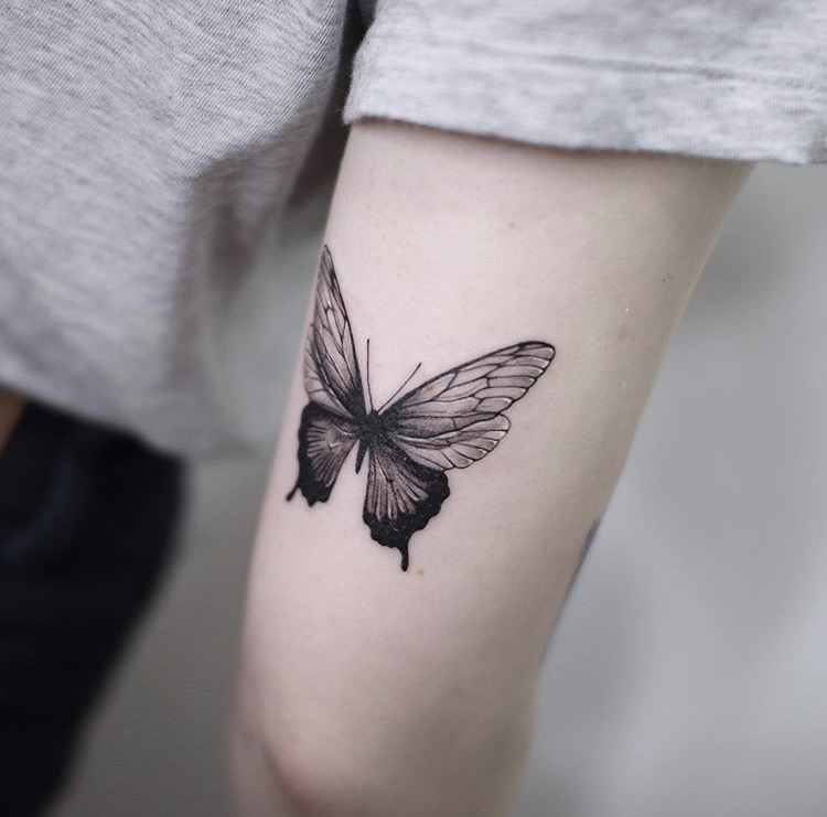 Black And Blue Flying Butterfly Tattoo On Right Back Shoulder