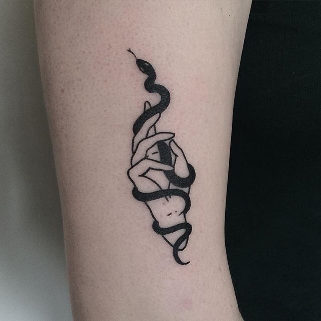 Minimalist snake tattoo on the wrist