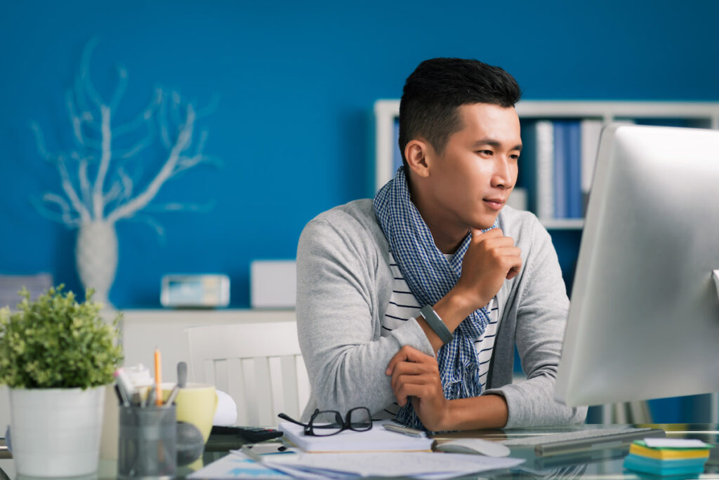 Man Looking at a Desktop Imac