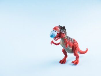 Angry dinosaur toy with easter egg in mouth