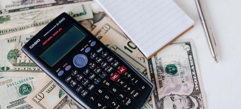 A calculator, money, and a notebook.
